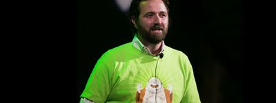 a man with a beard wearing a green shirt