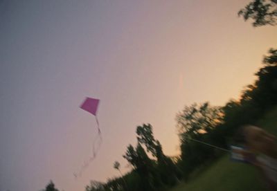 a person flying a kite in a field