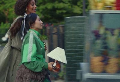 a couple of women walking down a street