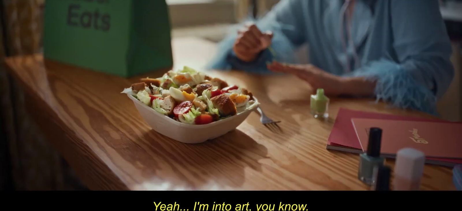 a person sitting at a table with a bowl of food