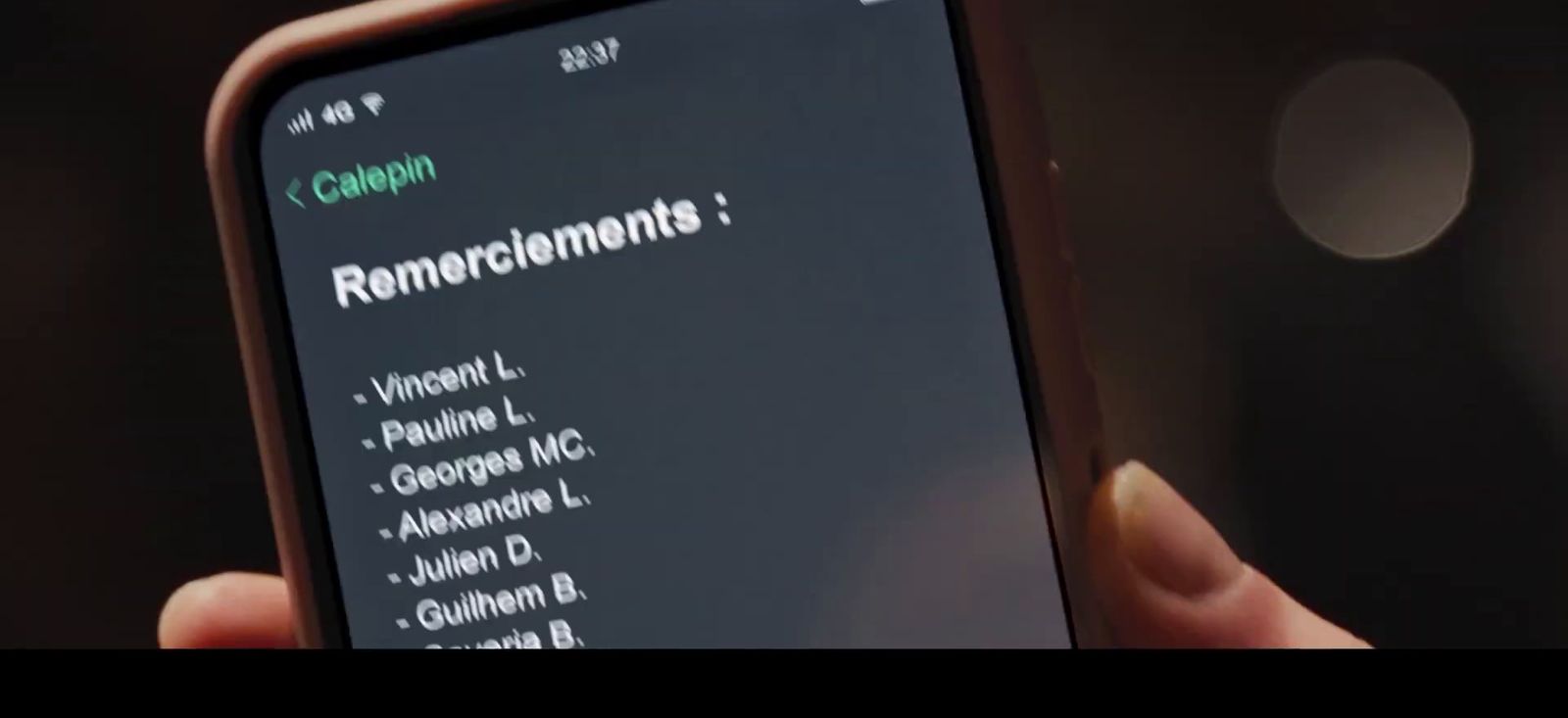 a person holding a cell phone in their hand