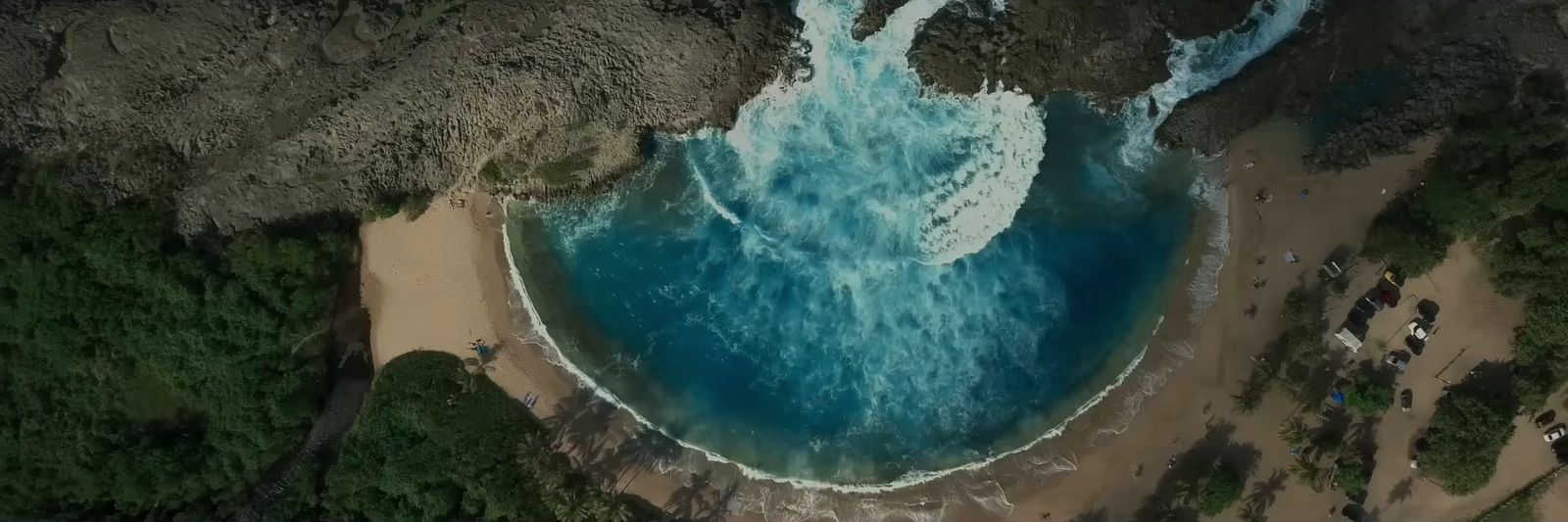 an aerial view of a beach with blue water