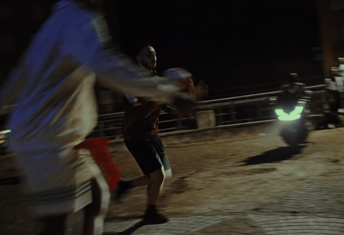 two men playing a game of baseball at night