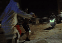 two men playing a game of baseball at night