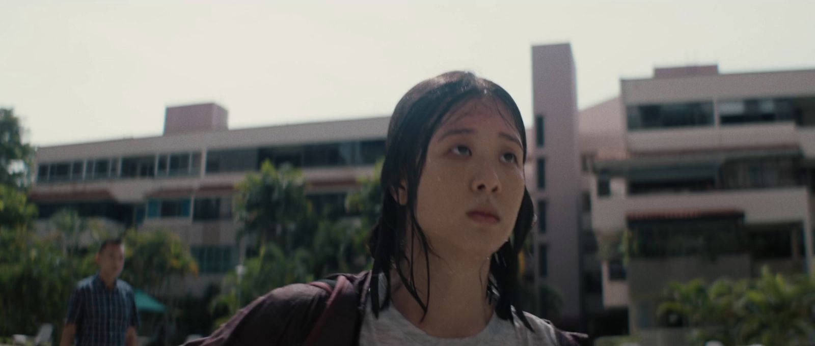 a young woman standing in front of a building