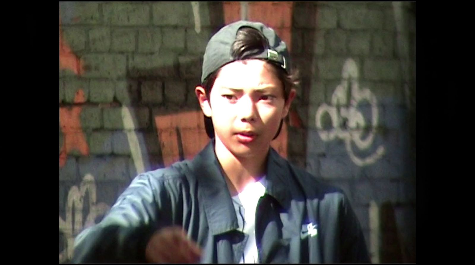 a young man wearing a hat and jacket