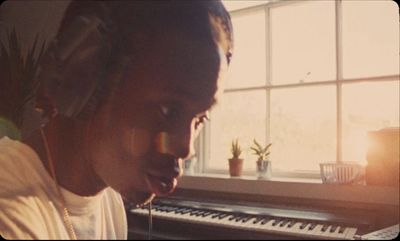 a person with headphones on in front of a keyboard