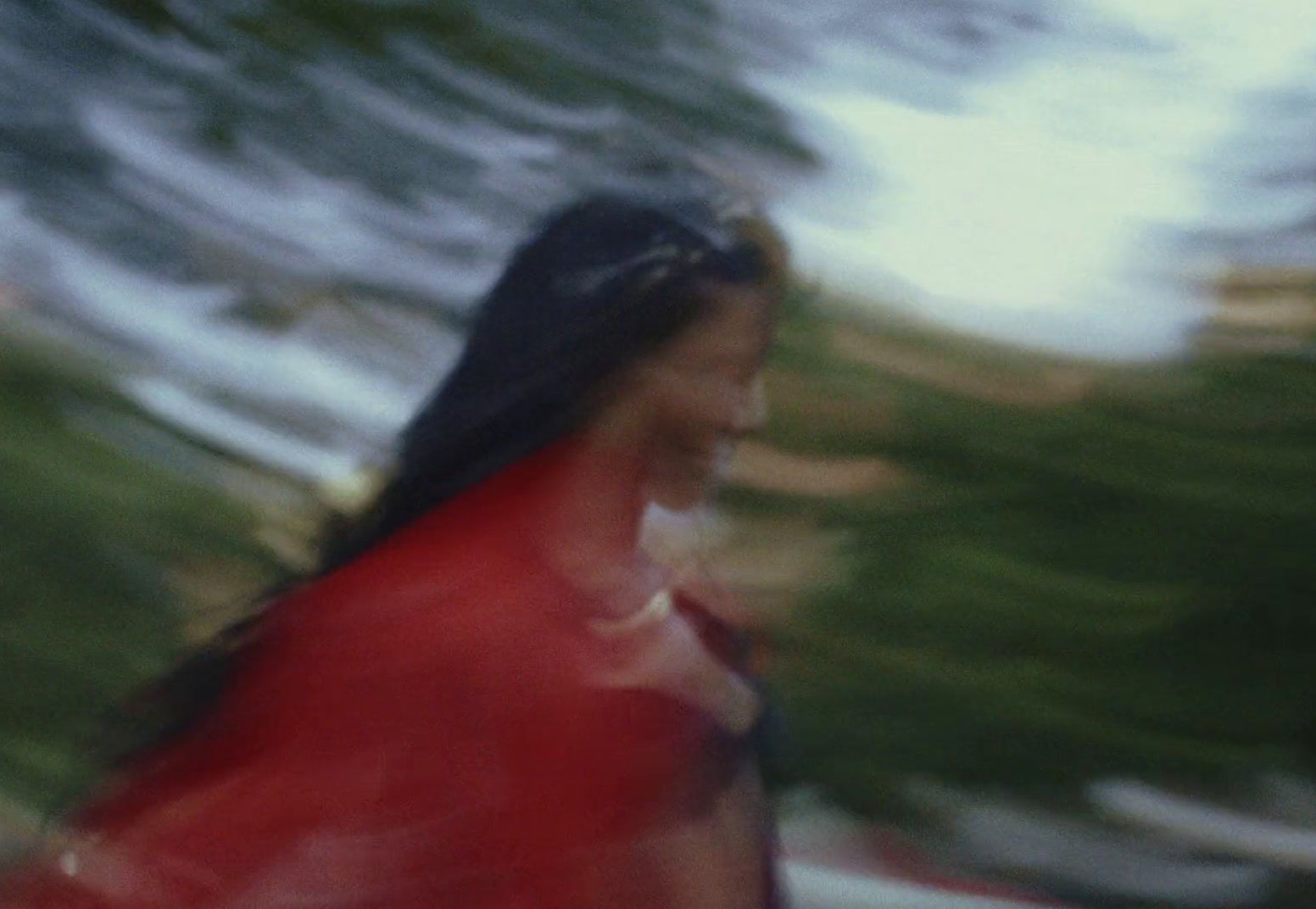 a blurry photo of a woman in a red shirt