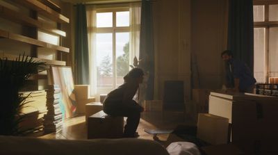 a man standing in a living room next to a window