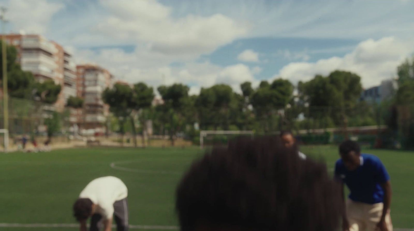 a group of people standing on top of a soccer field