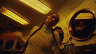 a woman standing in front of a dryer in a room