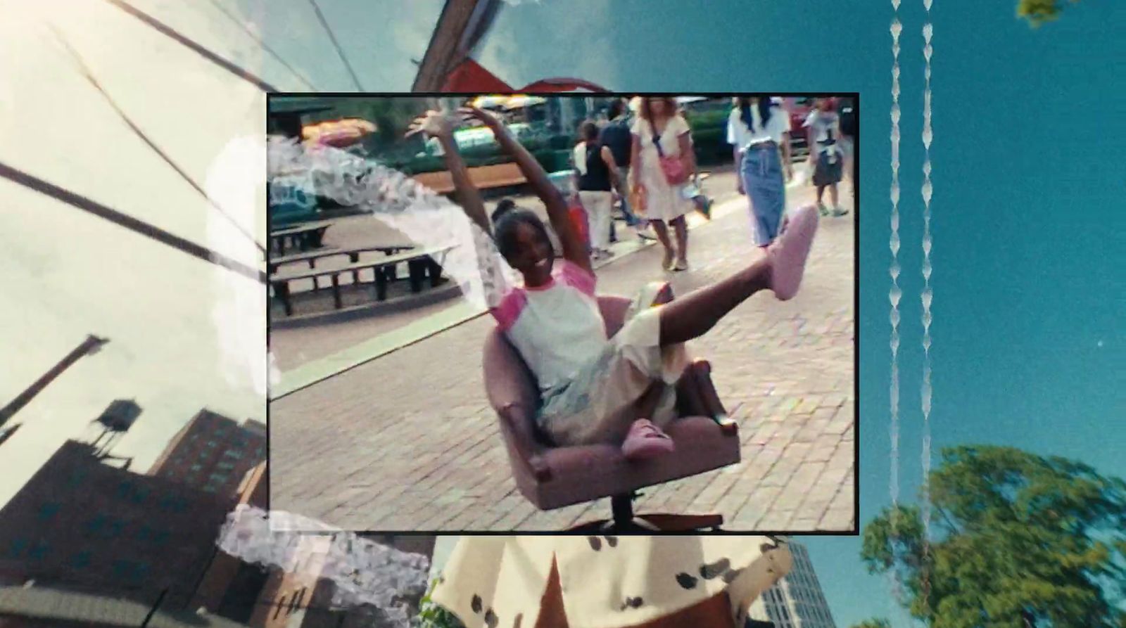 a woman sitting in a chair on a city street