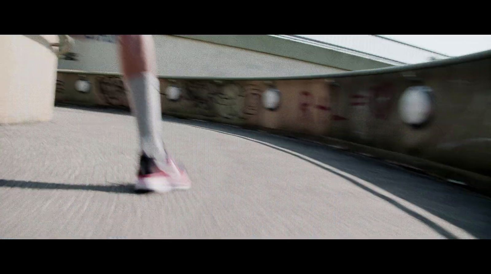 a person walking down a street next to a train