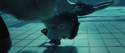 a man riding a skateboard on top of a tiled floor