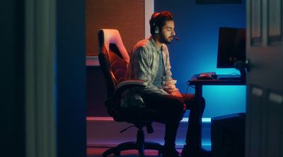 a man sitting at a desk with headphones on