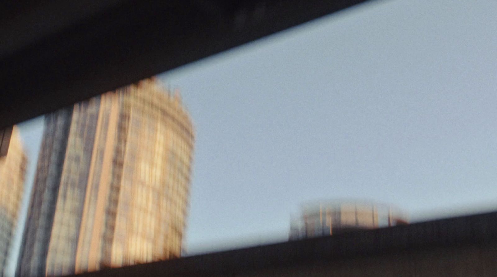 a blurry picture of a city with tall buildings