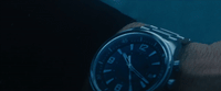 a watch that is on someone's wrist in the dark