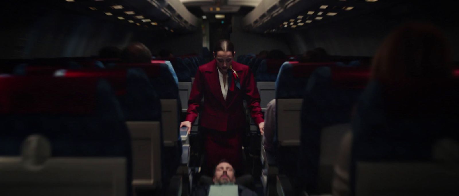 a man in a red suit is on a plane