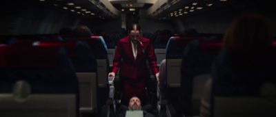 a man in a red suit is on a plane