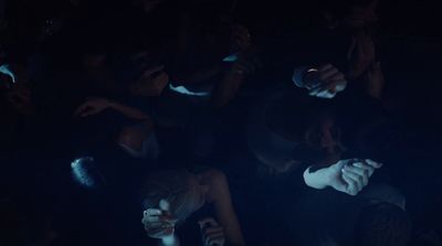 a group of people sitting in a dark room