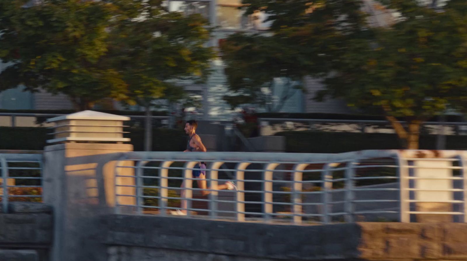 a man riding a skateboard across a bridge