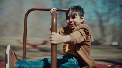 a young boy is playing on a slide