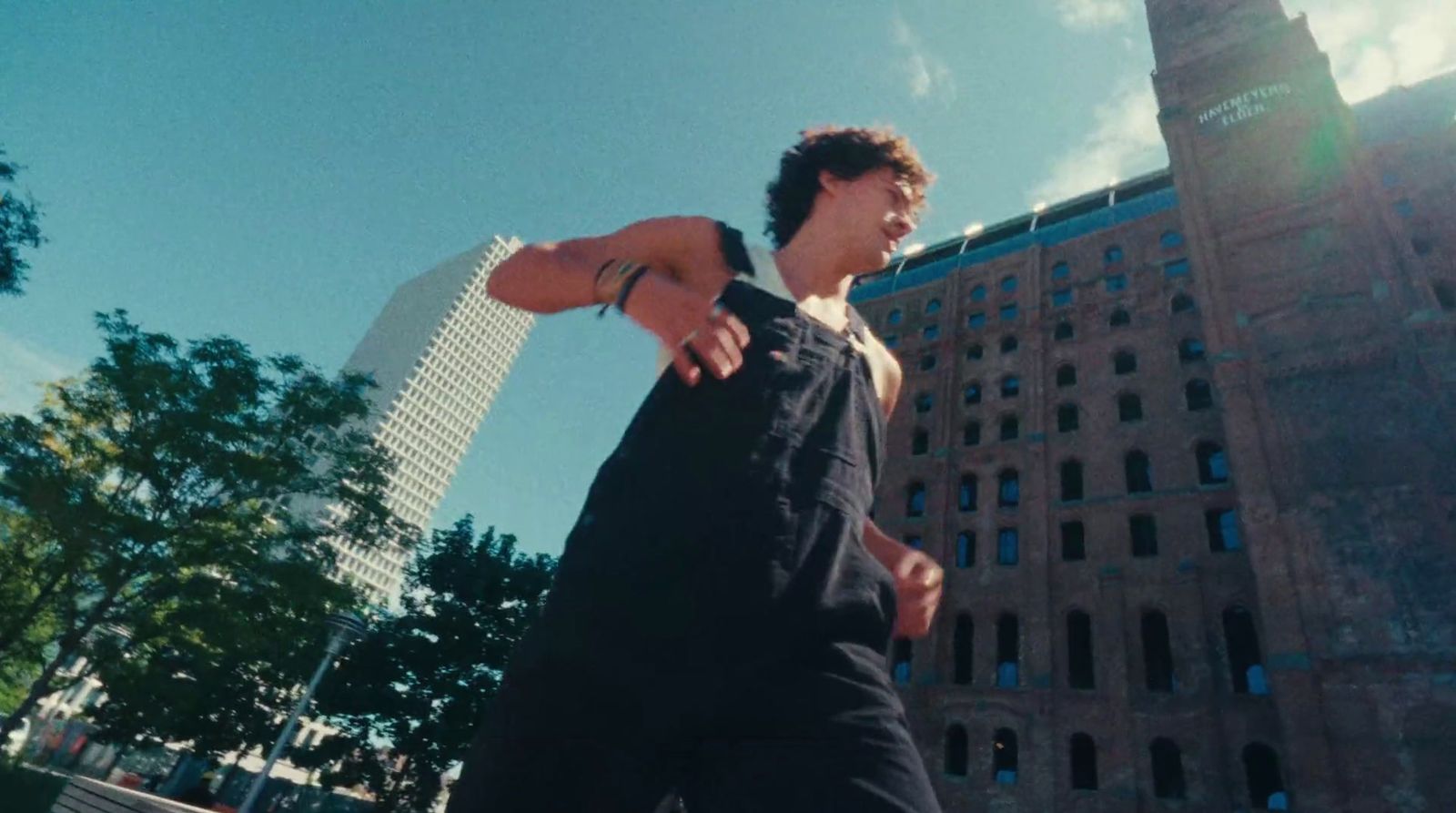 a man riding a skateboard in front of a tall building