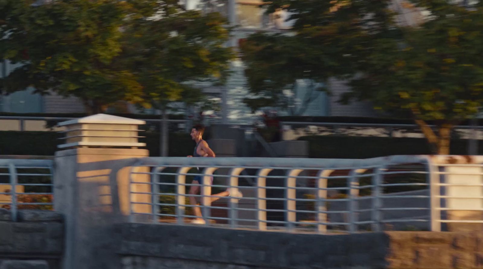 a man riding a skateboard across a bridge