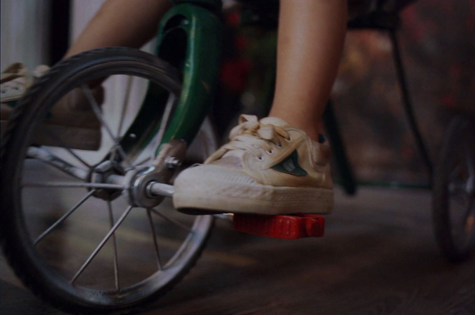 a person riding a skateboard on a wooden floor