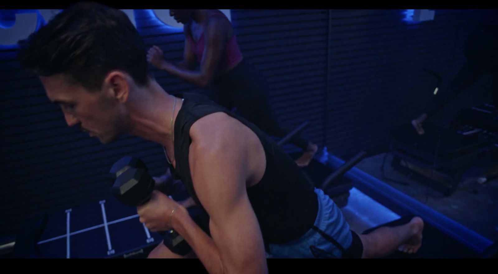 a man lifting a barbell in a gym