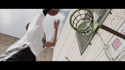 a man reaching up to grab a basketball