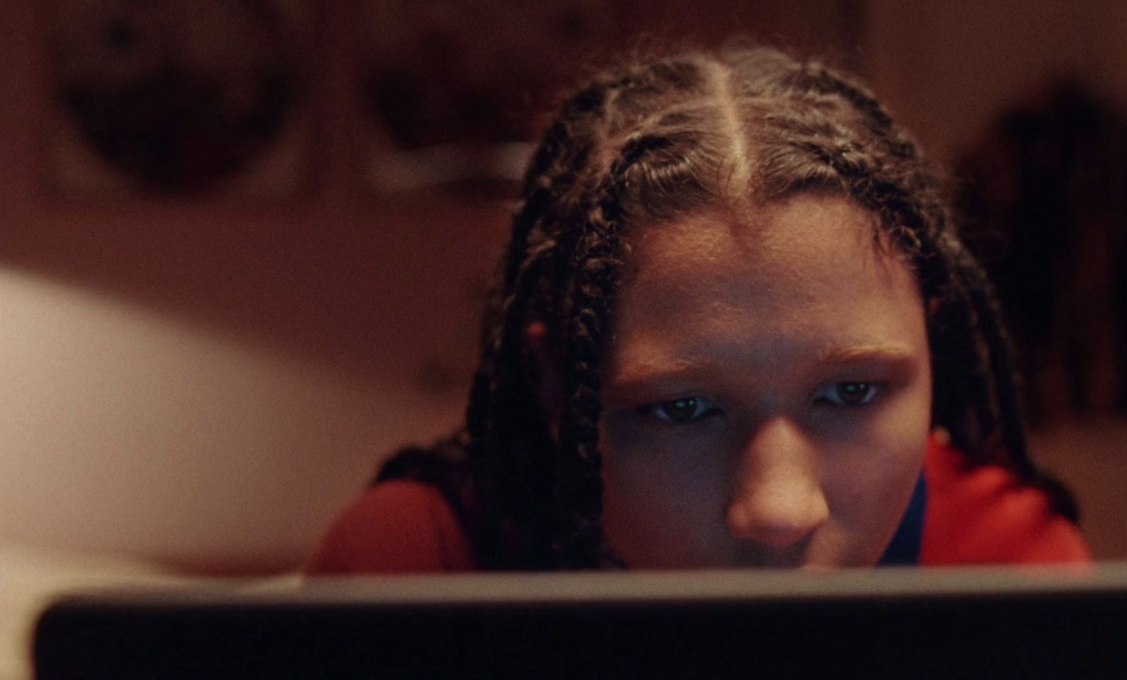 a young girl looking at a computer screen