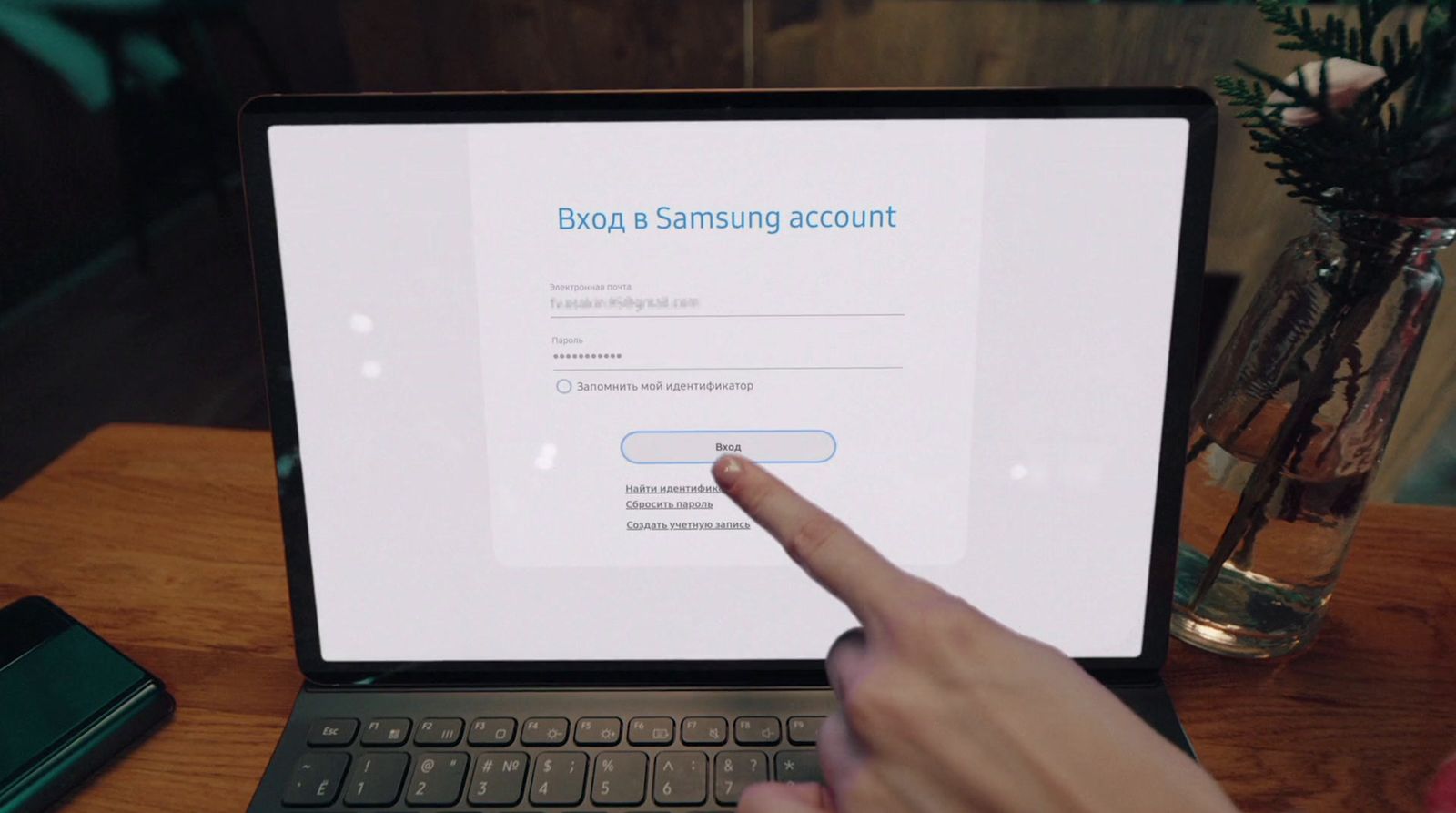 a person pointing at a samsung account on a laptop