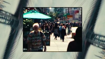 a group of people walking down a sidewalk