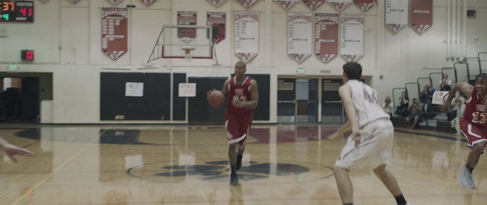 a group of young men playing a game of basketball