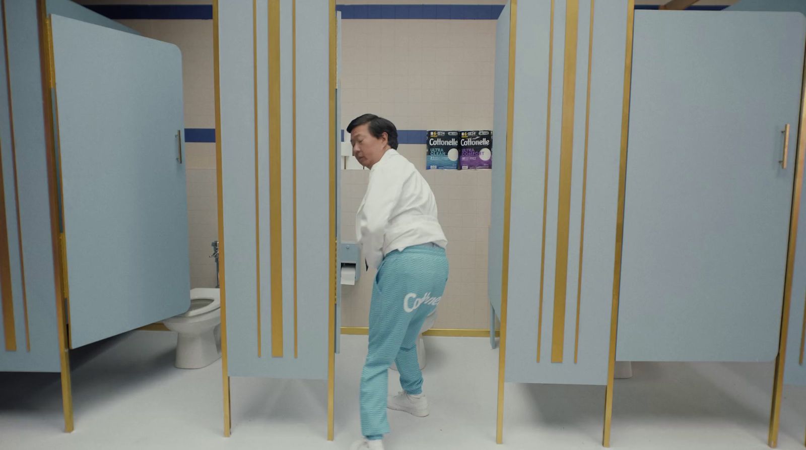 a woman standing in front of a toilet in a bathroom