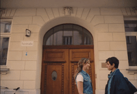 a man and a woman standing in front of a door