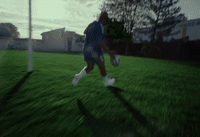 a blurry photo of a man running across a field