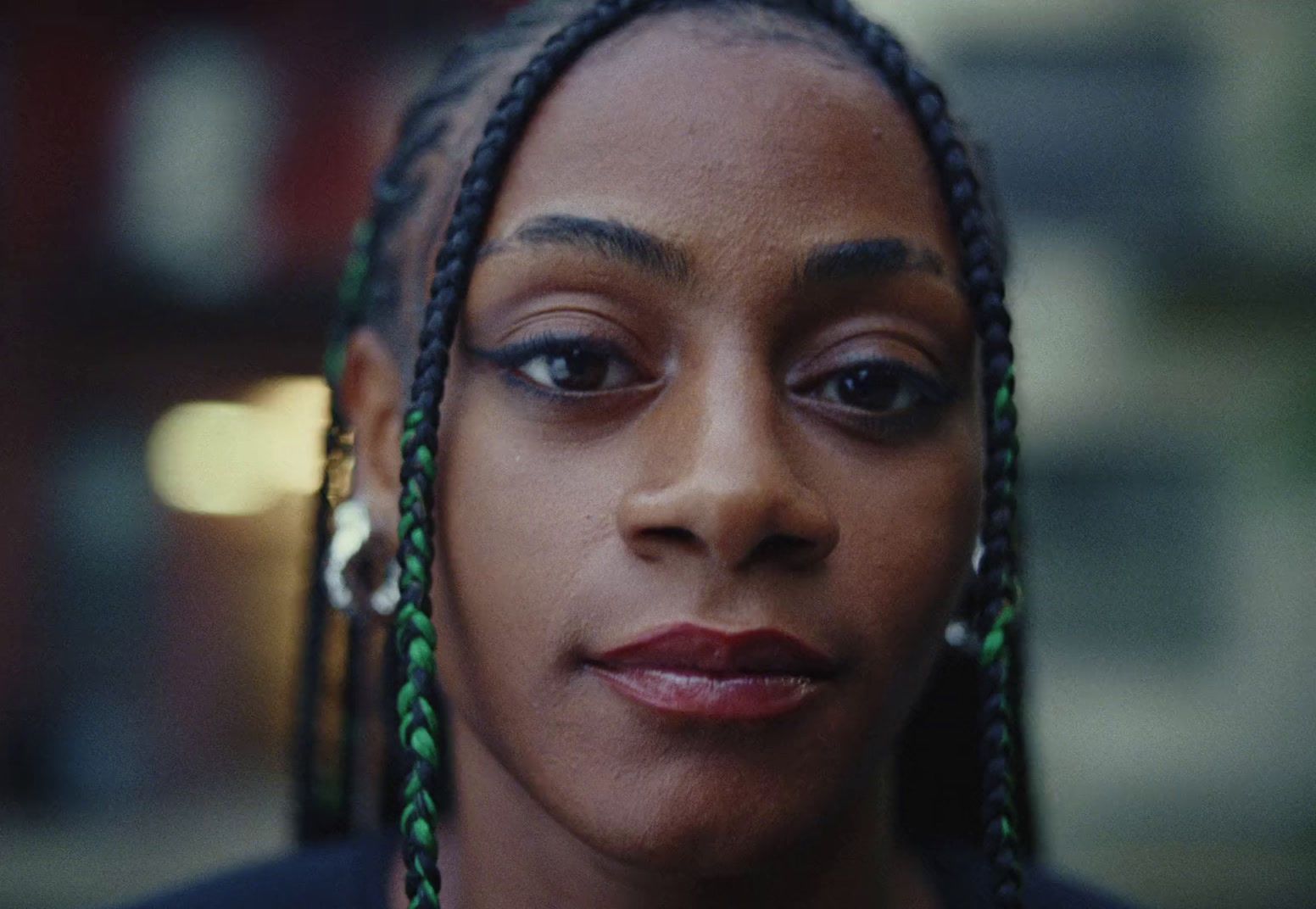 a close up of a person with braids on her hair