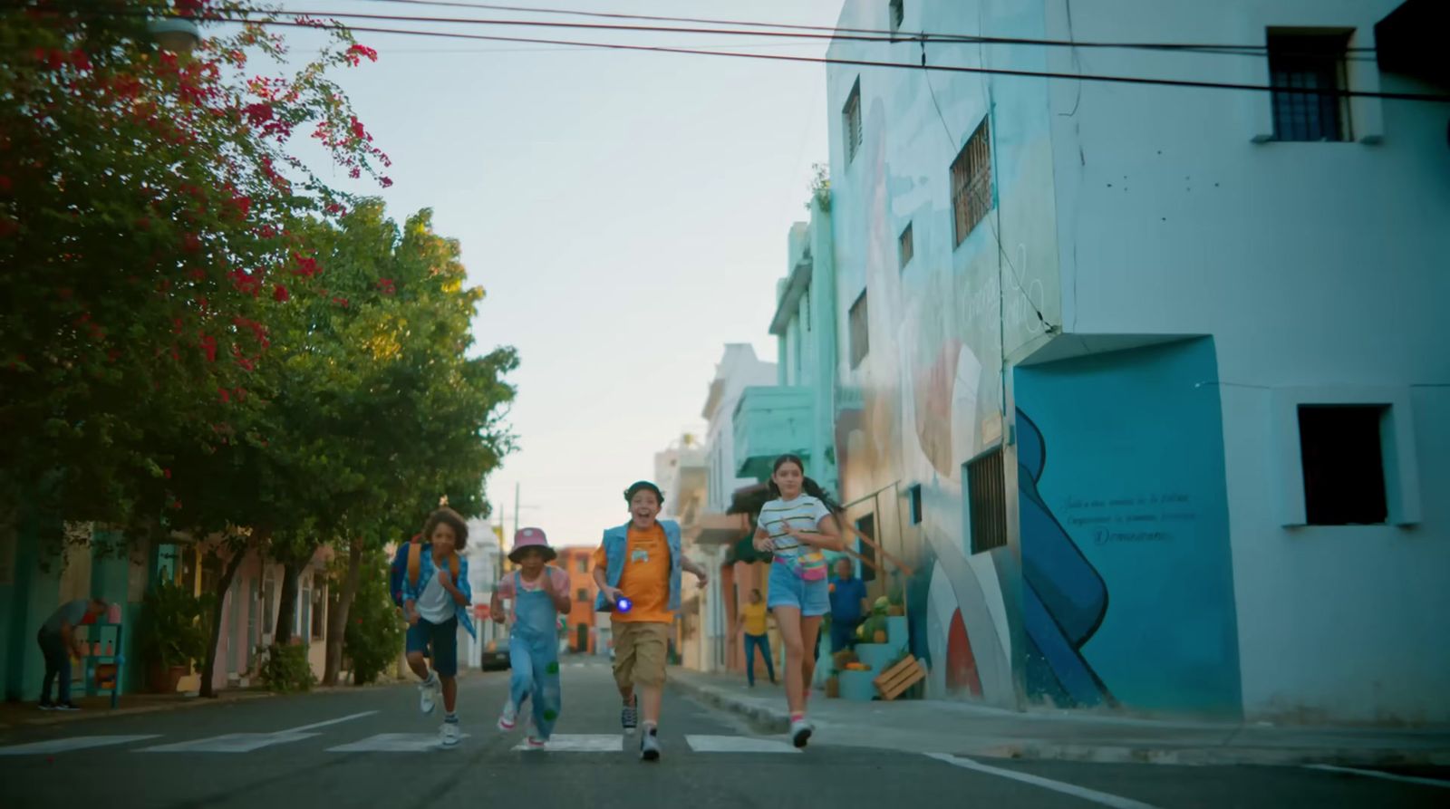 a group of people walking across a street