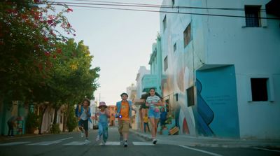 a group of people walking across a street