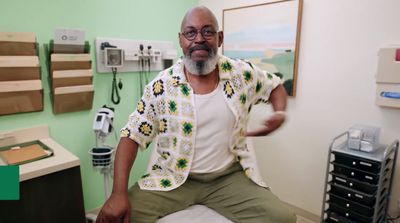 a man sitting on a bed in a hospital room