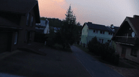 a view of a street with houses in the background