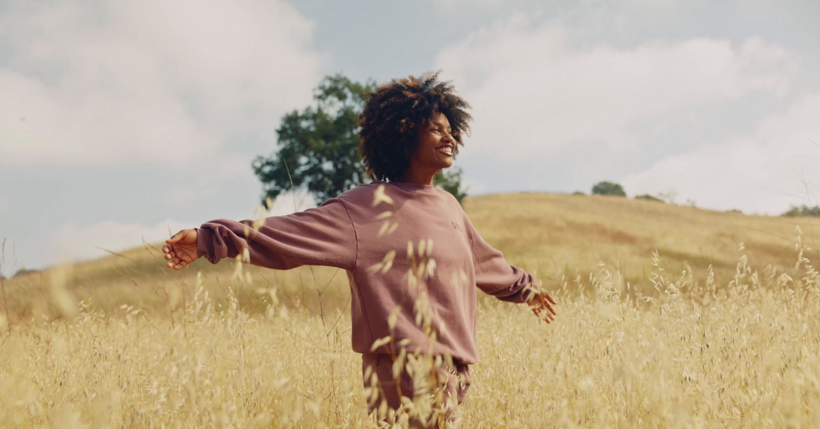 a young person standing in a field of tall grass