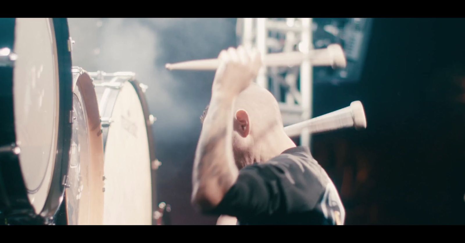 a man is playing drums on a stage