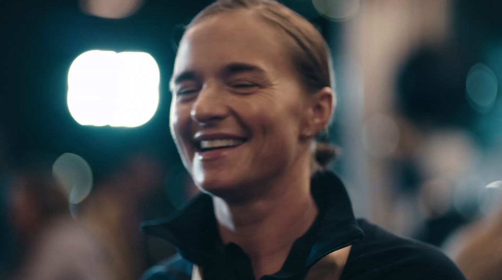 a man smiling and wearing a black shirt