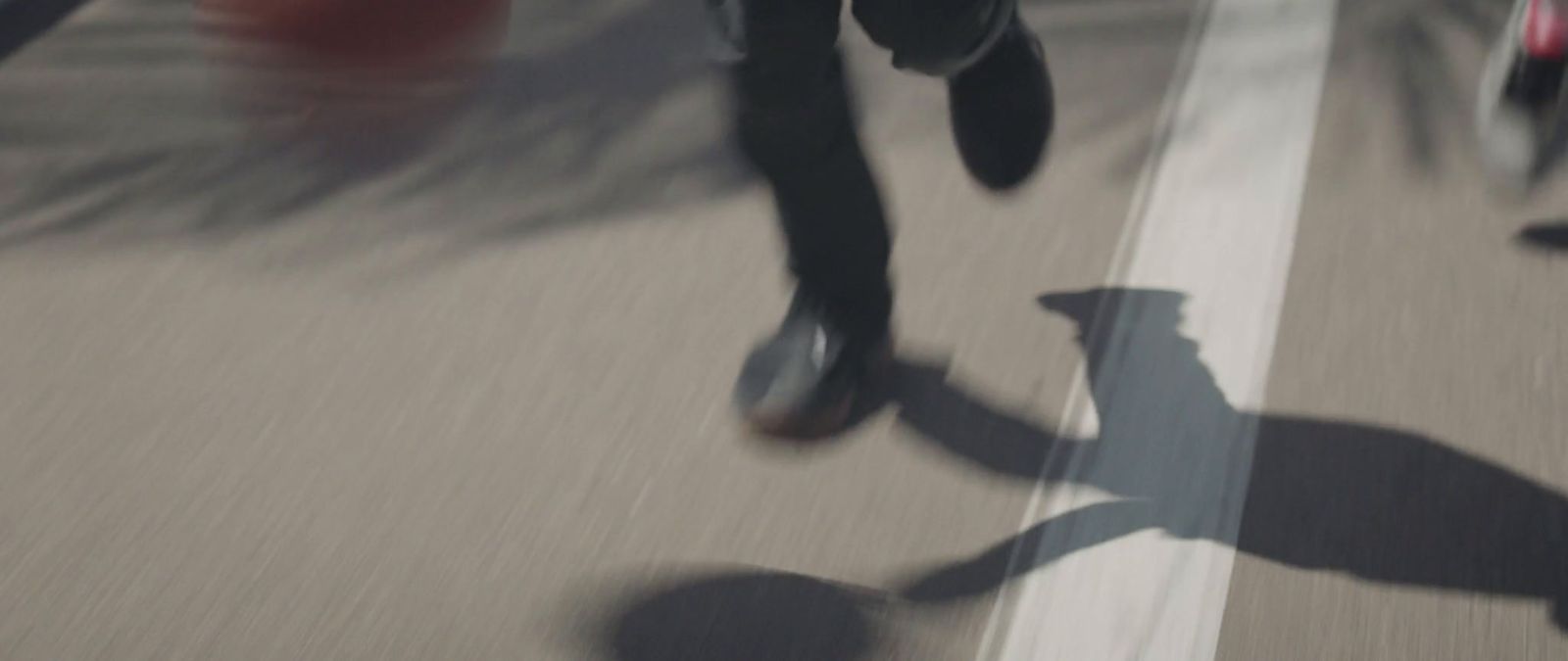 a group of people riding skateboards down a street