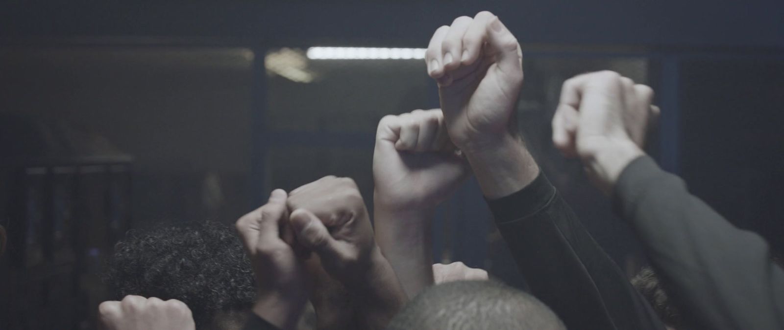 a group of people raising their hands in the air