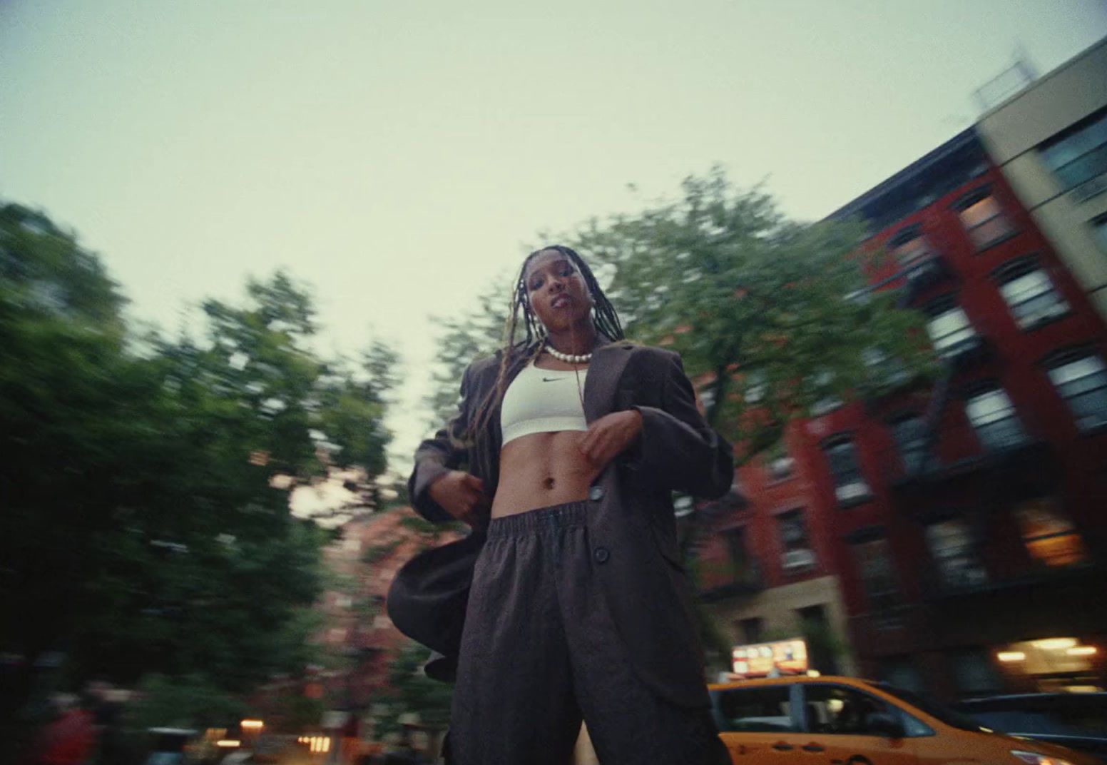 a woman riding a skateboard down a street