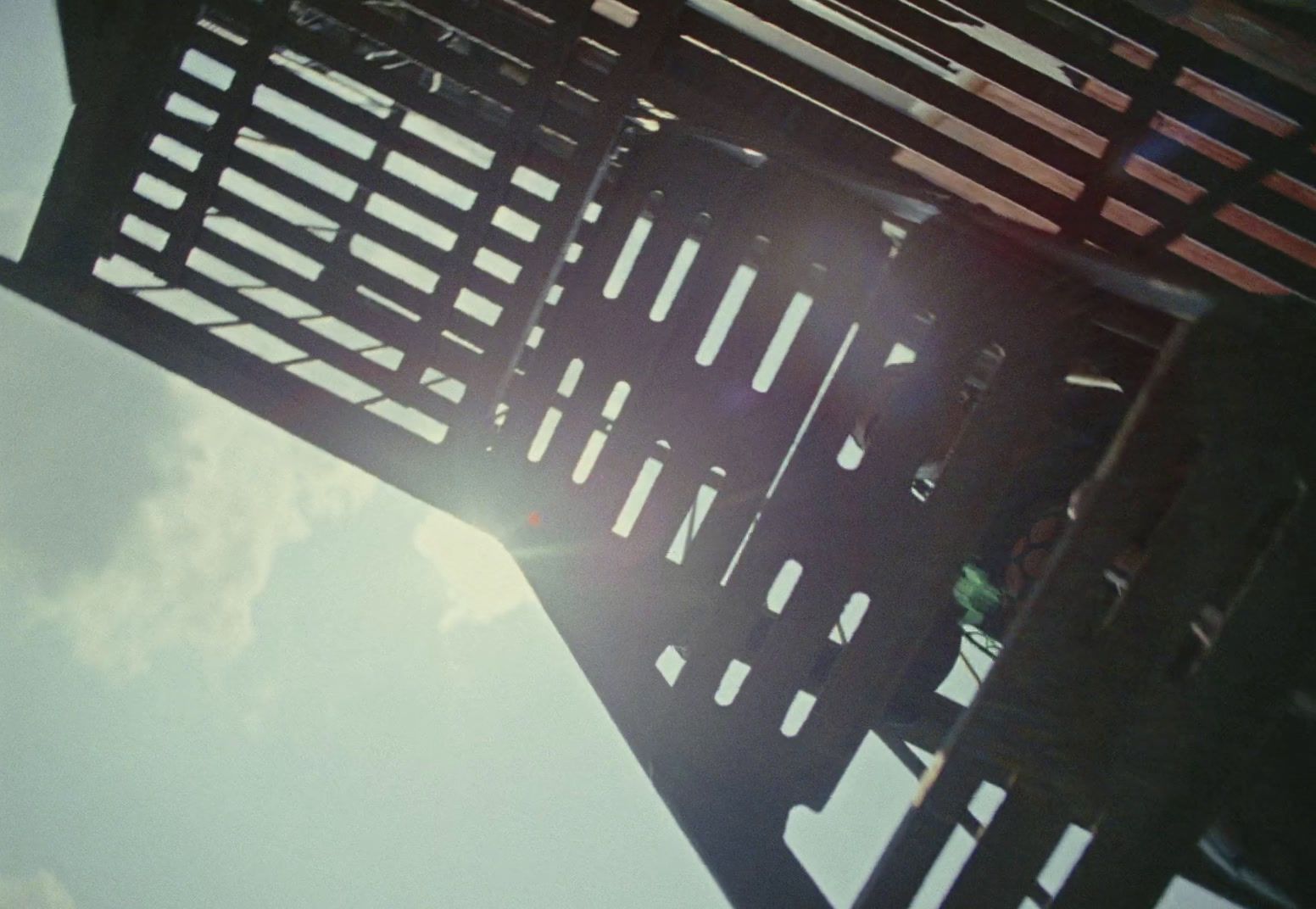 a close up of a metal structure with a sky background